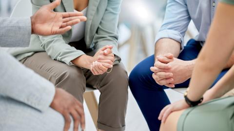 A photo of several people sitting close together